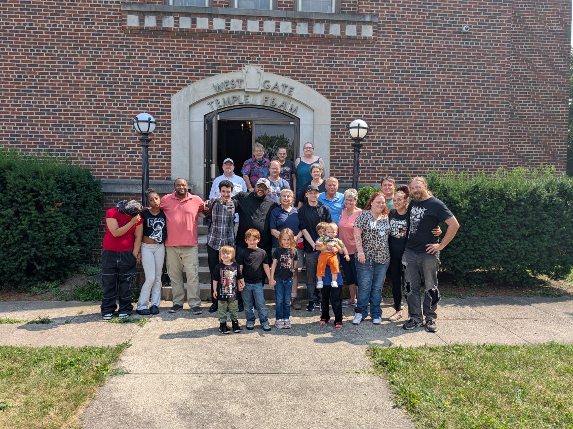 Members and family gathered on the steps of West Gate Temple