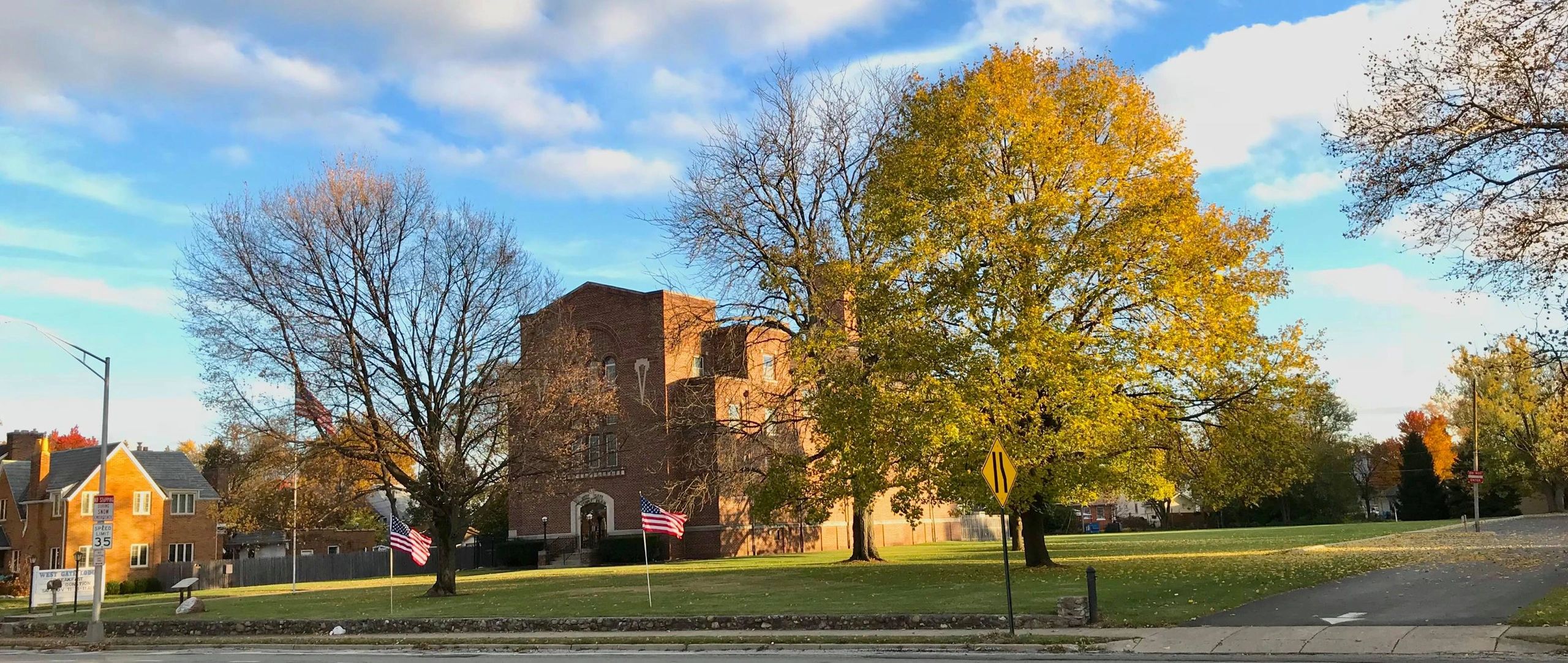 West Gate Masonic Temple at 2925 W. Broad Street, Columbus, with flags and autumn trees